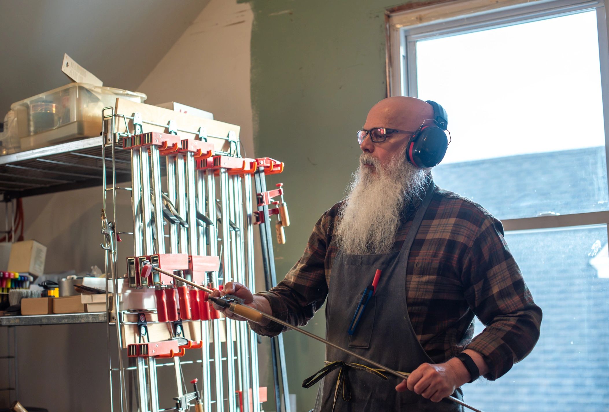 Experienced craftsperson selecting tools in a workshop