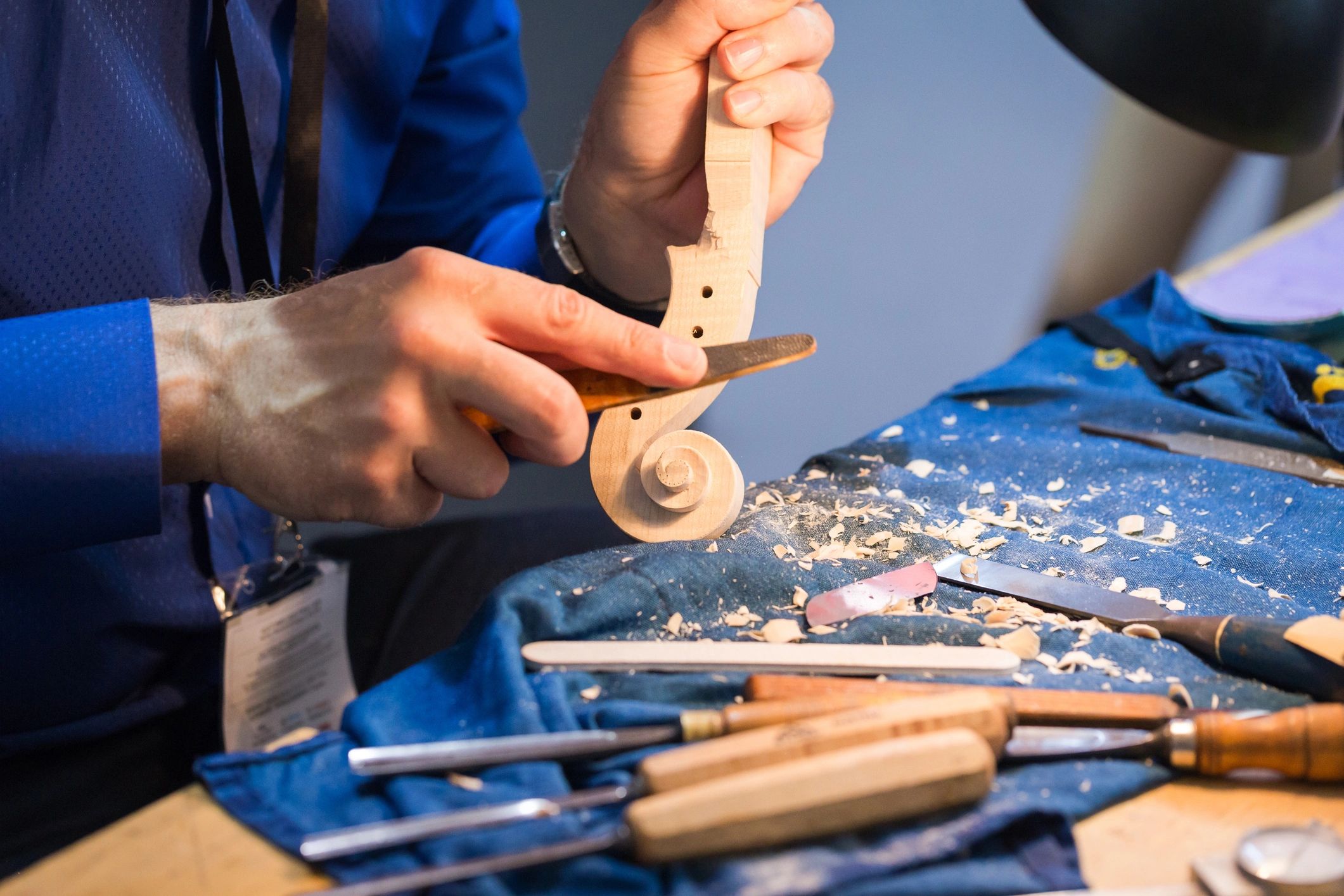Craftsperson working on a violin scroll